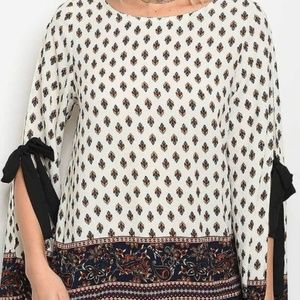 Ivory top with pattern and tie sleeve detail